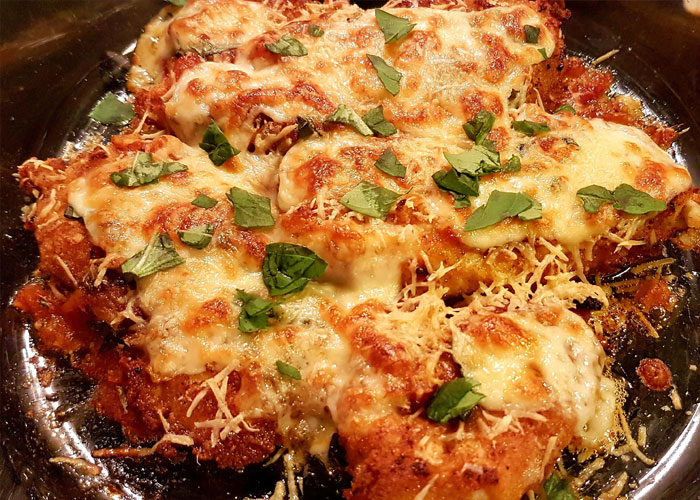 Chicken Parmesan is not an Italian dish, it was invented in America by Italian immigrants and the first published recipe was in a NY newspaper in 1953. The dish became wildly popular in Australia where its served with salad and fries, although they hotly debate if the fries go under the chicken