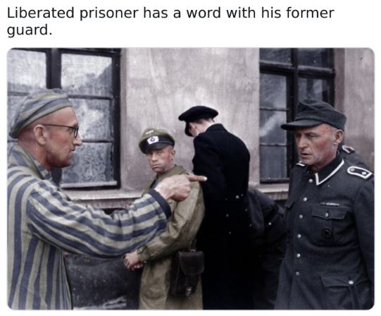 Fascinating historical pics - military officer - Liberated prisoner has a word with his former guard.