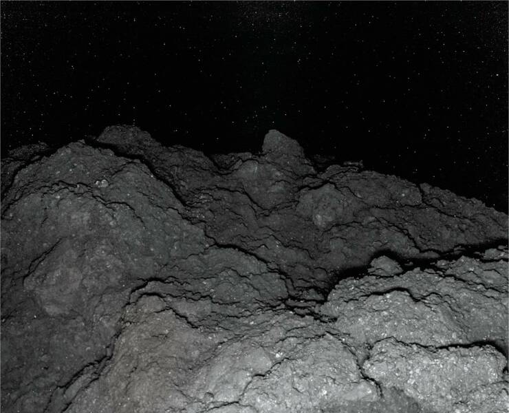 "This is a photo of the surface of asteroid 162173 Ryugu. Taken at night by Hyabusa-2"