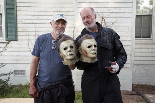 Nick Castle and James Jude Courtney — who both play Michael Myers — hold up their prized masks on the set of Halloween (2018):