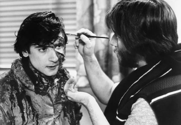 Makeup artist Rick Baker makes Griffin Dunne look extra scary between scenes on An American Werewolf in London (1981):