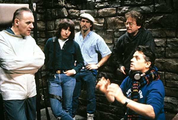 Anthony Hopkins and director Jonathan Demme have a totally normal chat on the set of The Silence of the Lambs (1991) while a film crew watches on: