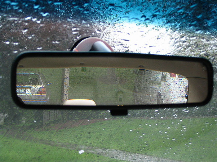 The car rear view mirror has a prism that you can turn with the flipper to dull the reflection of high beams.