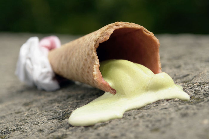 Went to bed in a hotel room with the balcony door open because it was hot. Had a bad dream of a guy in a red checked shirt peering into the room, entering, and eating an ice cream at the end of the bed. When I woke up I discovered a half melted banana colored ice cream between the bed and the wall.