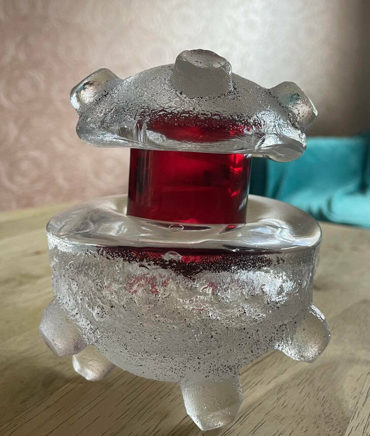 “Heavy glass ornament. At least 3 kg. One part is removable. 13 cm high. It’s transparent and red glass.”

Answer: “From the looks of the red part, it’s probably a fancy votive candleholder, and the top part is meant to snuff the candle out when you’re done.”