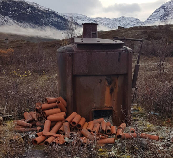 “Huge rusty old oven surrounded by clay pipe, in the middle of nowhere Northern Sweden.”

Answer: “Probably an old kiln”