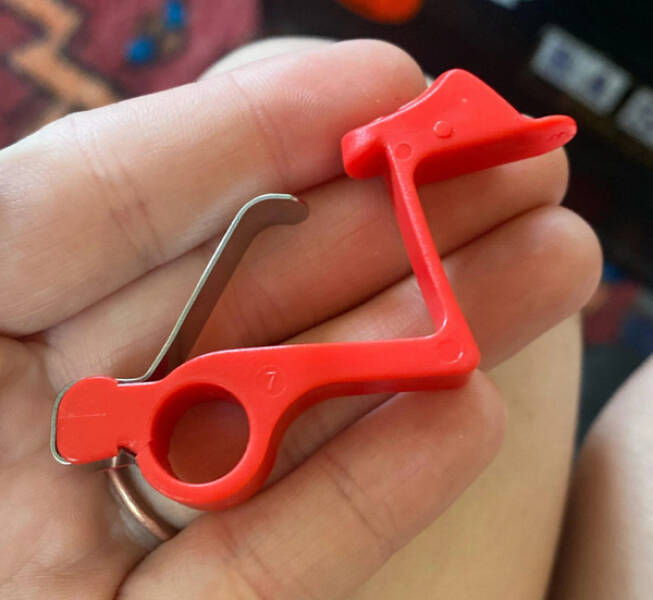 “A little red plastic and metal tool, the metal is springy. It has a lock stamped on the short end and a number 7 stamped on the flat side.”

Answer: "I believe it is a locking mechanism for a Zyliss Lock N’ Lift can opener."