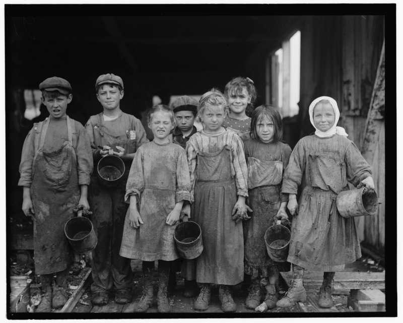 These children from 8 years old up go to school half a day, and shuck oysters for four hours before school and three hours after school on school days, and on Saturday from 4 a.m. to early afternoon in Maggioni Canning Co., Port Royal, South Carolina, 1911. photo by Lewis Wickes Hine