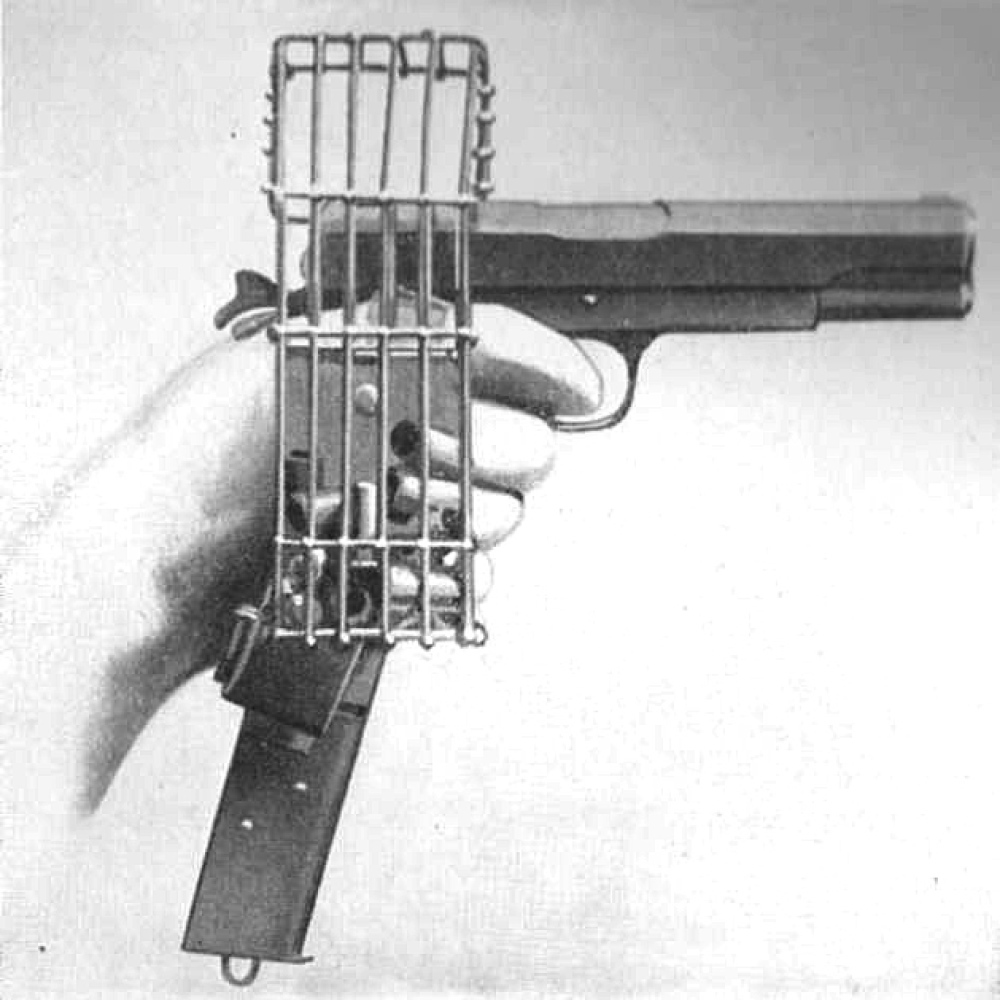 US .45 cal M1911 pistol with extended magazine and brass catching cage. In the early days of WW1 and aircraft didn’t have machine guns, enemy pilots would shoot at each other with pistols. The cage prevented the spent shells from ejecting onto the cockpit floor and interfere with the foot controls