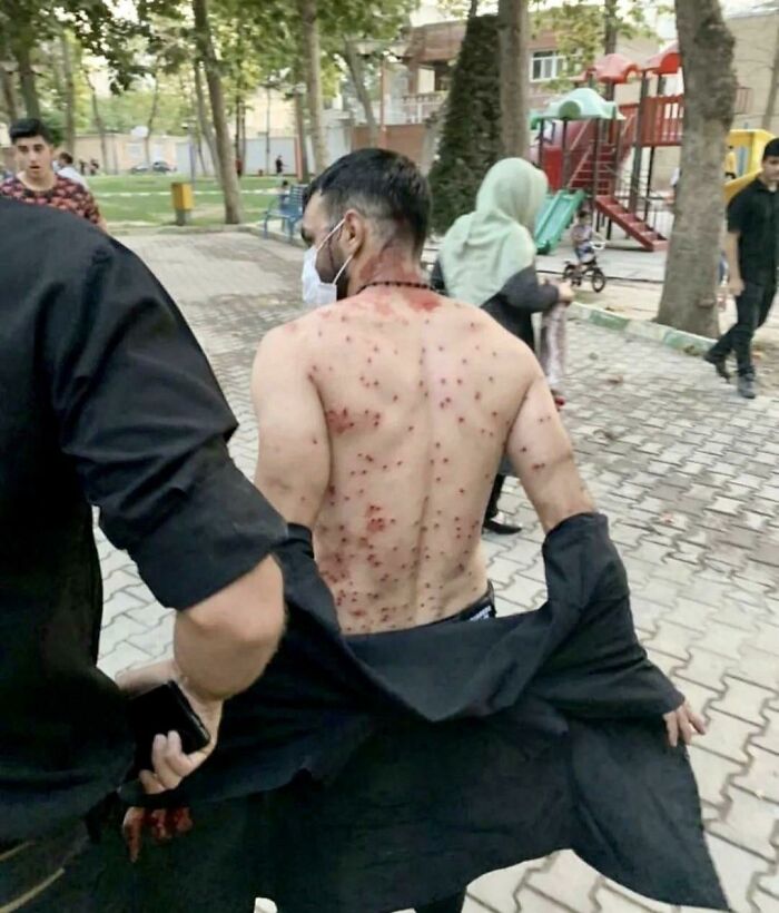 creepy and wtf pics - man shields women in iran