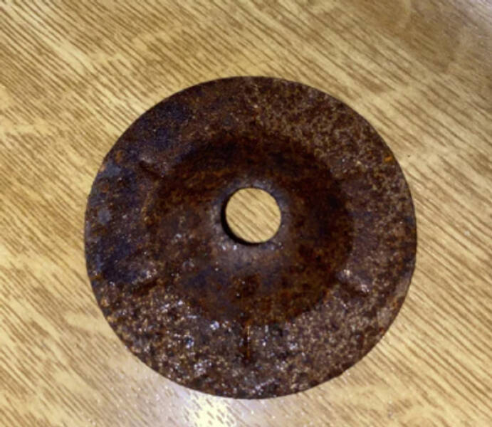 "My husband and I moved into our first apartment with a dishwasher. In the utensil basket, we found metal."

“That looks like a dimpled or countersunk washer to me. They are used in a wide variety of applications, however, I doubt they would have used a mild steel variety in such an inhospitable environment.”