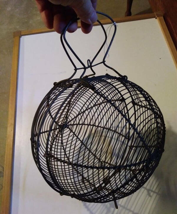 "I found this secondhand, and it opens up. It’s made of metal. What is it?"

“Could be a lettuce drier. My dad used a basket like this to dry off lettuce he just washed. Spun it around outside.”