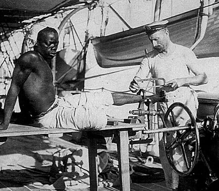 A British Blacksmith Removing The Leg Irons Off A Slave, 1907, Off Coast Of Mozambique