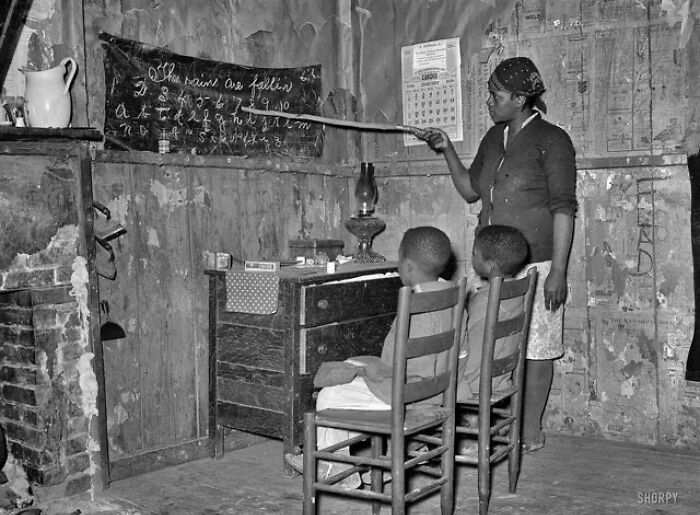 Mother Teaching Children Numbers And Alphabet In Home Of Sharecropper. Transylvania, Louisiana. Jan. 1939. Photo Taken By: Russel Lee