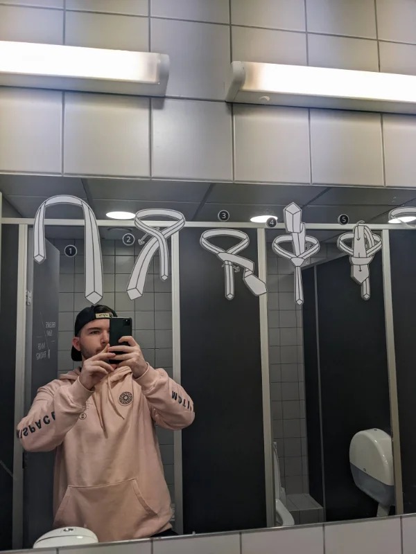 “This bathroom mirror in Tallinn Airport has instructions on how to tie a tie.”