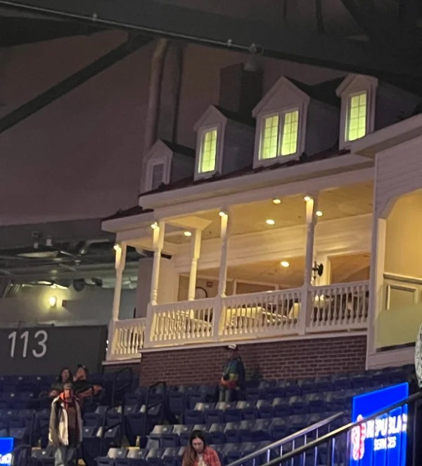 “Hockey arena with a “front porch” club box.”