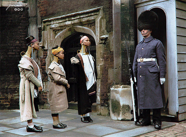 “Giraffe women” looking at a guard, posted at St. James’ Palace 16th century main gate, during their visit in London, 1935