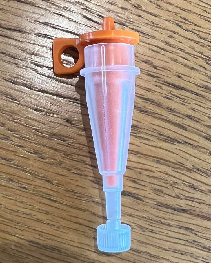 ’’Small 4 cm plastic funnel, inside a clear plastic funnel with a twist off base/lid.’’

’’I think it’s a PEG / G-tube adaptor. You push/ screw the thin end into the tubing attached to the liquid feed bag, and then push the conical end into the PEG tube. Or you use the clear outside to connect the G-tube to a syringe.’’