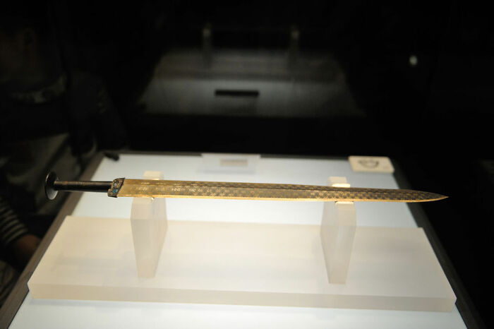 In 1965, an excavation team discovered the Sword of Goujian in a tomb in Hubei, China. Encased in a nearly air-tight wooden box next to a skeleton. The sword is over 2500 years old but was in perfect condition, test affirmed that the blade could easily cut a stack of twenty pieces of paper.