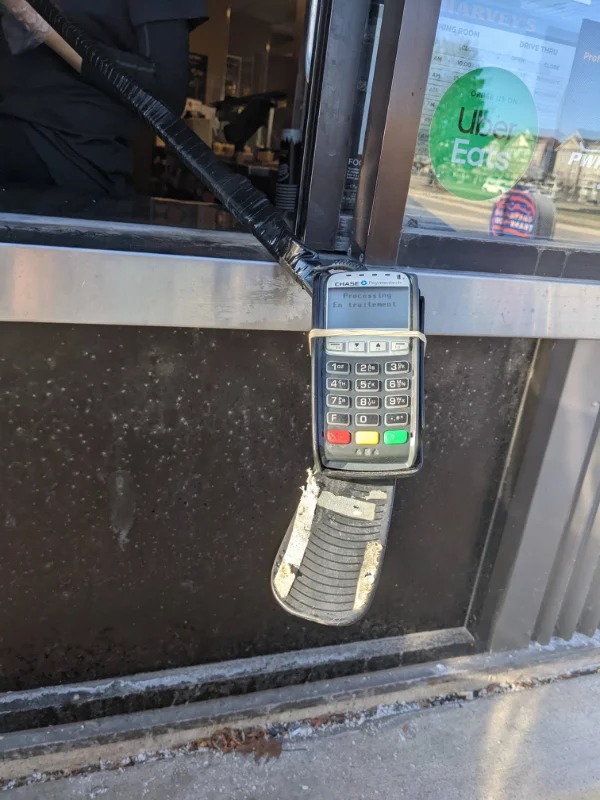 “This drive-thru in Canada has their debit card machine attached to a hockey stick.”