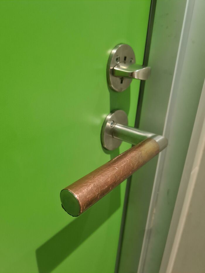 Brass Or Copper Like Thing In Bathroom Door Handle.
Answer: Copper kills bacteria and germs.