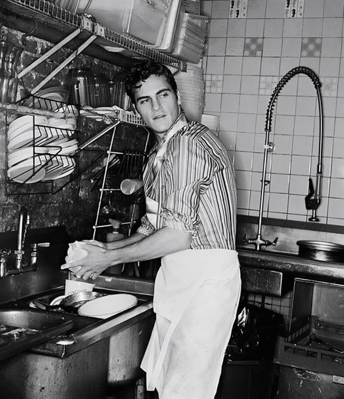 historical photos -  joaquin phoenix washing dishes