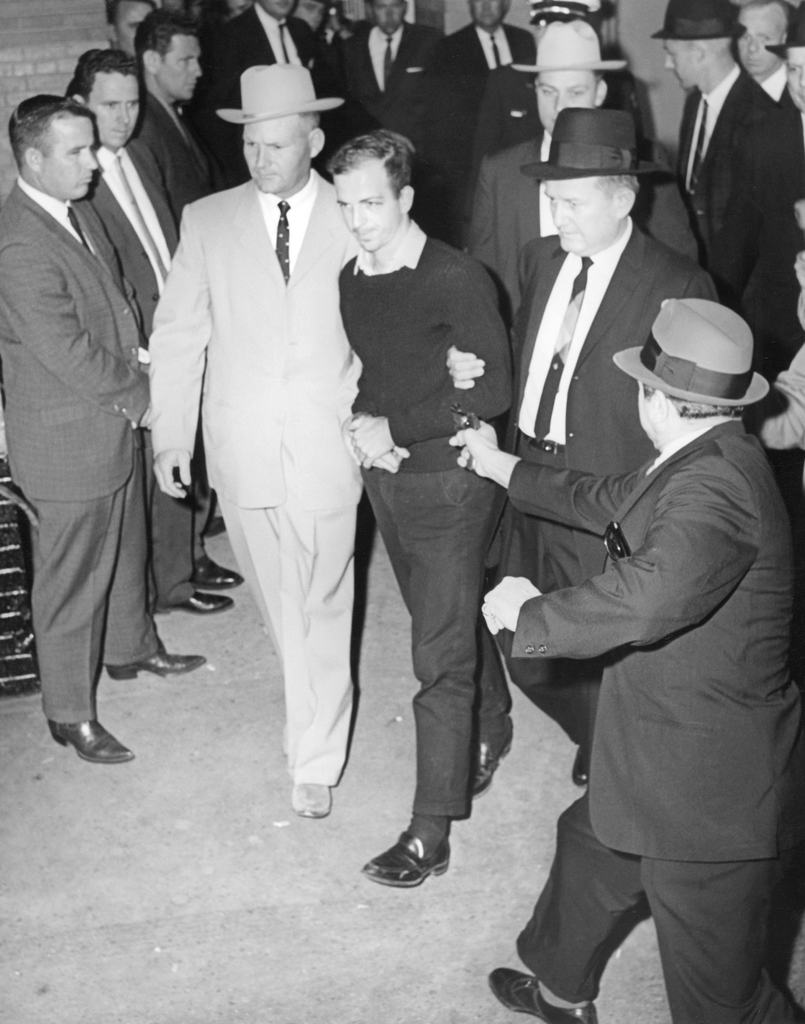 Lee Harvey Oswald being escorted by a detective, moments before being shot by Jack Ruby (in the grey fedora on the right). November 24, 1963