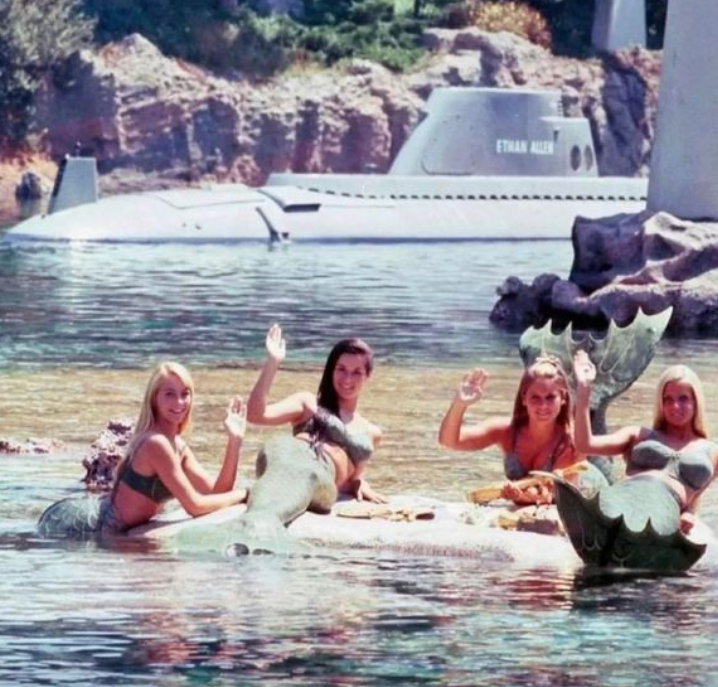 fascinating pics from history - - “Mermaids” in Disneyland waving at passengers on the submarine ride. c.1960