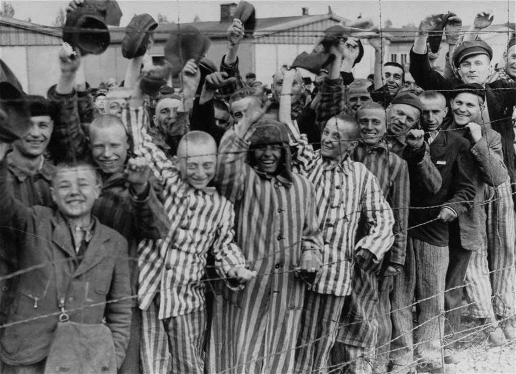 fascinating pics from history - Prisoners celebrating the arrival of United States Army troops, Dachau Concentration Camp, Germany, 29 April 1945