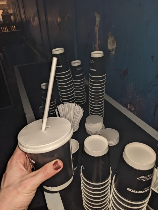 “Cups with lids at club.”
