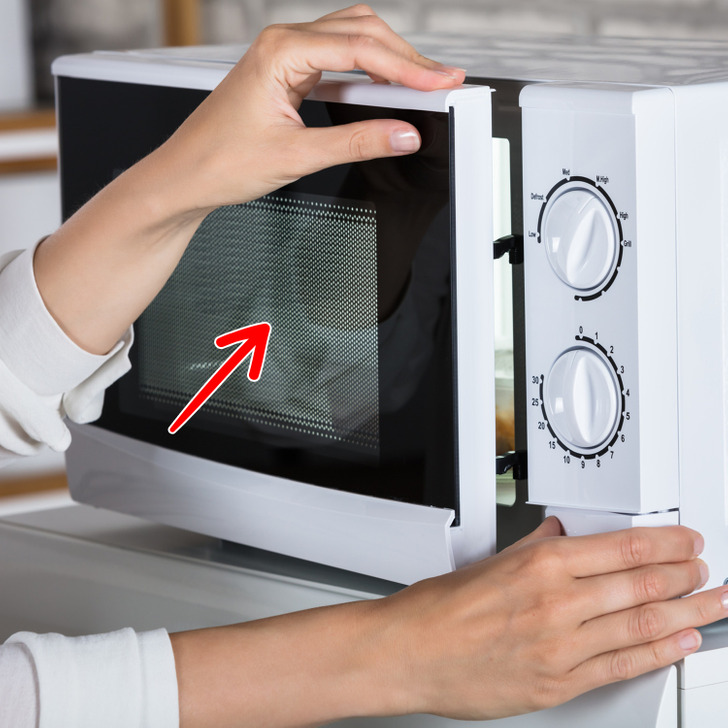 The microwave has a black grate for your safety. This black grate is called a faraday shield. It contains electromagnetic energy inside the oven. Also, it protects you from radiation and speeds up the heating process.