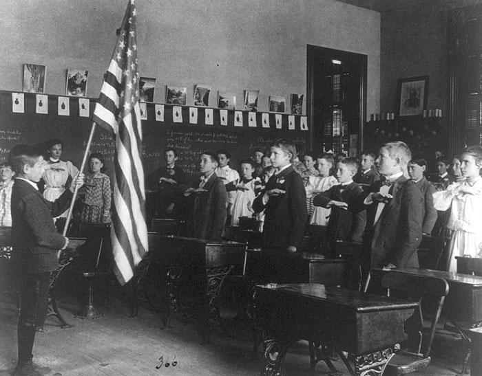 “Under God” was not in the original version of the Pledge of Allegiance. The Pledge was written in 1892. It wasn’t until 1954 that President Eisenhower added “under God” in response to fear of communism during WW2. Also - when first implemented, during the pledge people raised their right arm forward so the hand was level with their eyes (directed at the flag) however this was changed during WW2 because it resembled the Nazi salute. The procedure was changed to place the right hand over the heart.
