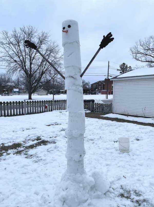 This tall, skinny snowman made with buckets:
