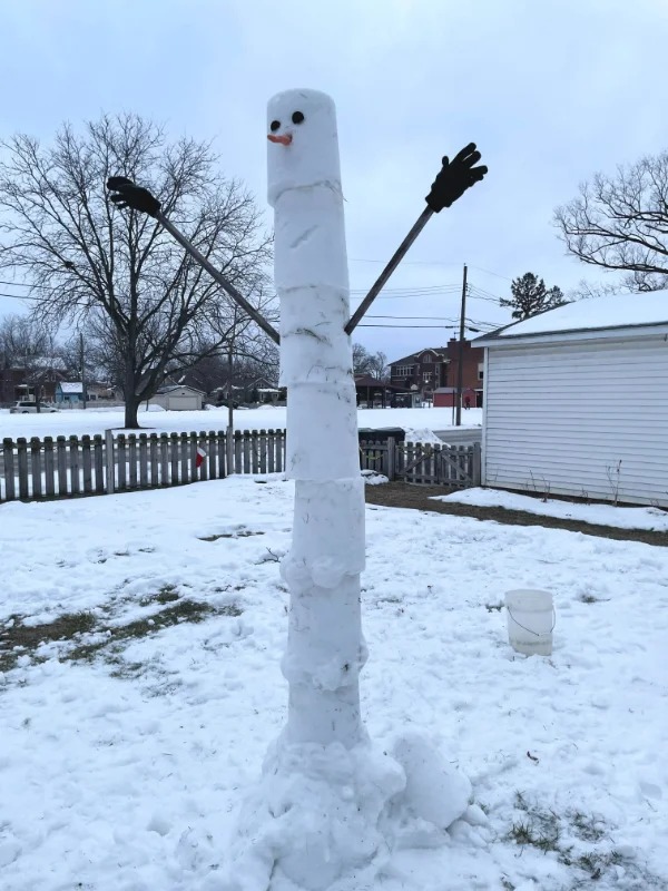 “Tall skinny snowman made with a bucket.”