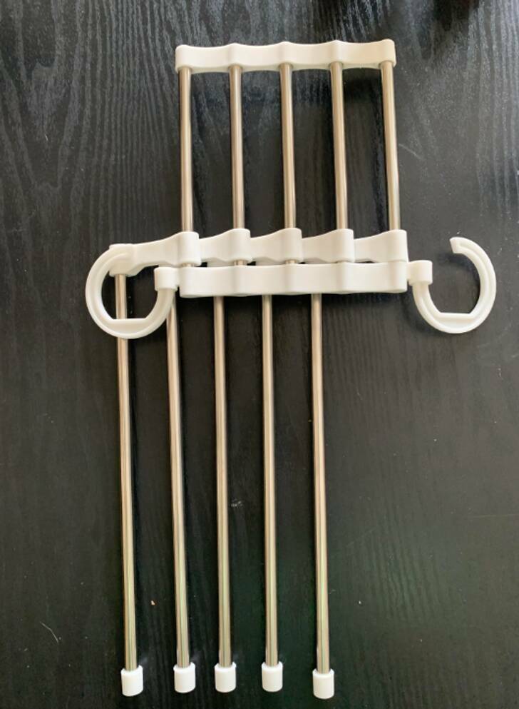 “I received this for Christmas — hollow metal tubes that swing around when you move it and 2 plastic hooks.”

“It’s a space saving multi-hanger.”