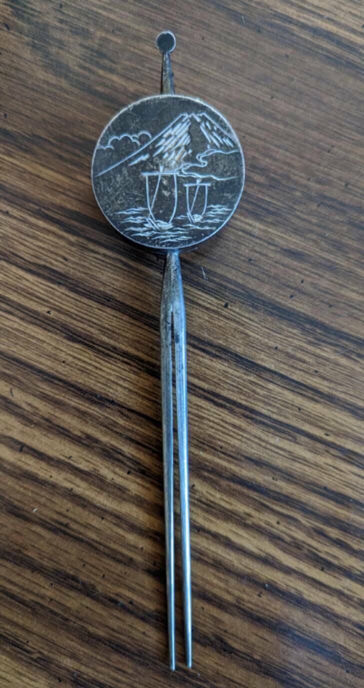 “Sterling silver, 6 inches long, a small compartment on the back.”

“There should be some small holes on the edge. It’s a salt and pepper shaker, one of a pair, Japanese. The image is a pair of sailboats with Mt. Fuji in the background.”