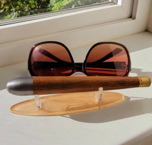 “Small torpedo-shaped metal and wood thing about the size of a pair of sunglasses. Mounted for display, found in an Airbnb with several others.”

“Google Lens brings up cedar plug fishing lure”