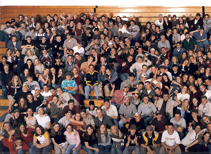 High School Class Photo.
This is the class of 99′ from Columbine High School and in the far left corner Eric Harris, Dylan Klebold and their friends are pointing pretend guns at the camera.