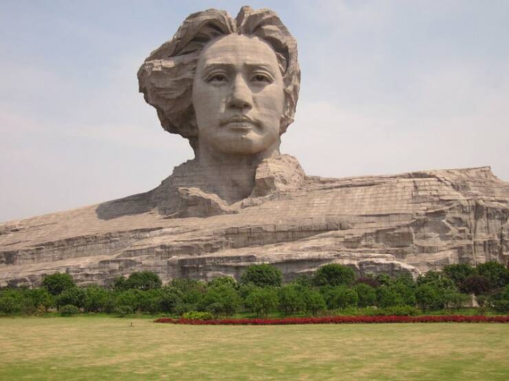 "Young Mao Zedong statue is located on Orange Isle in Changsha, Hunan. The monument stands 32 metres (105 ft) tall and depicts Mao Zedong’s head. The Hunan People’s Government began building it in 2007 and it was completed two years later, in 2009. It took more than 800 tons of granite"