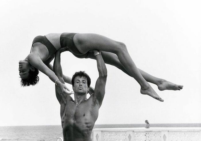 Behind Every Successful Woman Stands A Man Who... Well.. In Most Cases He Just Stands There For, You Know, Safety Reasons. Anyway, Here’s Brigitte Nielsen With Sylvester Stallone In 1986