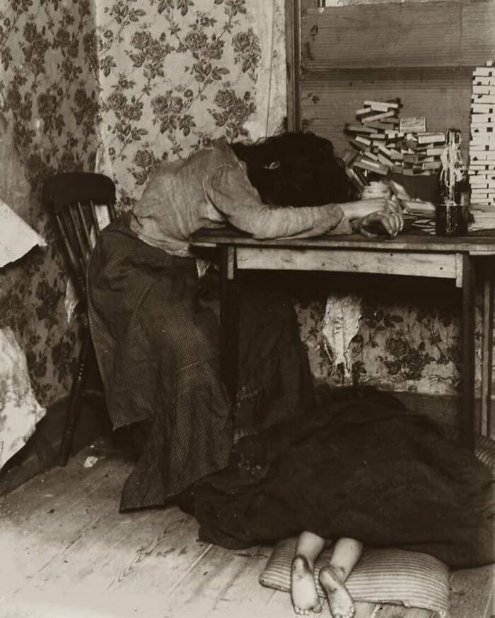 This Photograph Shows A Young Mother, Exhausted From Spending Hours Making Matchboxes, A Pile Of Which Can Be Seen On The Table