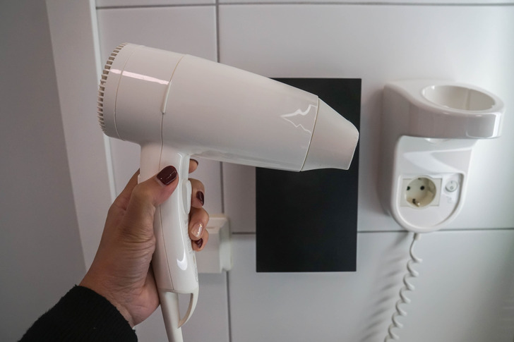 While state regulations require hotels to sanitize commonly touched areas, such as bathrooms and glasses, the same level of attention is not given to less noticeable items, like hair dryers. Consequently, these items may not be regularly cleaned by housekeeping and could go for extended periods without proper disinfection, causing bacteria to build up.