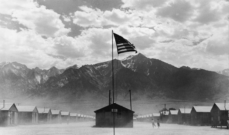 A US flag flies at the Manzanar War Relocation Center, a Japanese-American internment camp. The camp was a detention facility for some of the 120,000 Japanese-Americans excluded from the West Coast under wartime presidential Executive Order 9066 (Manzanar, California 1942)