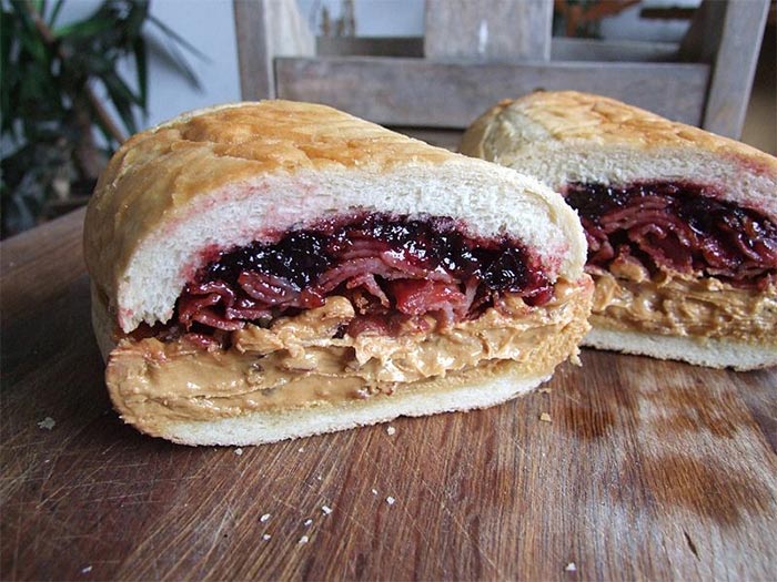 Elvis Presley craved the Fool's Gold Loaf, which consists of a hollowed-out loaf of French bread filled with one 1-lb. jar each of creamy peanut and grape jelly and a pound of fried bacon. It packs ~8,000 calories. He and friends once flew from Memphis to Denver to eat 30 of them.