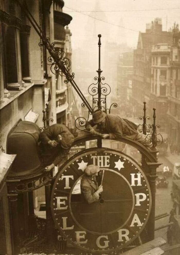 Workmen Dismantling A Clock, 1930