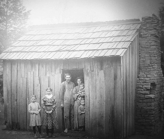 A Portrait Of A Family Standing In The Doorway Of Their Home, 1920s