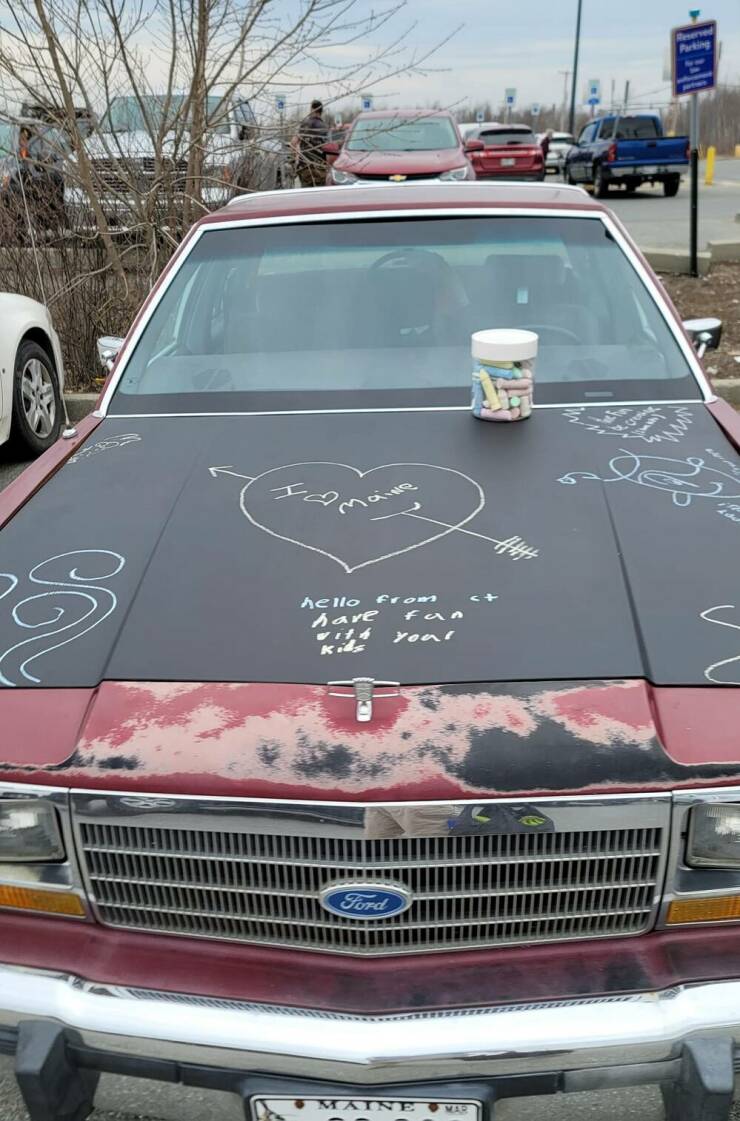 “This car has a blackboard paint hood and bucket of chalk, allowing anyone to doodle on it as they pass by in the parking lot.”