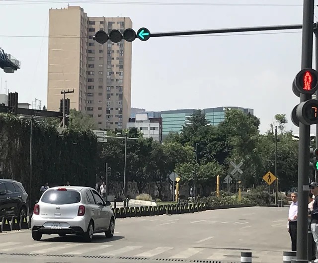 The design of this traffic lights pay homage to the decommissioned train tracks it hovers