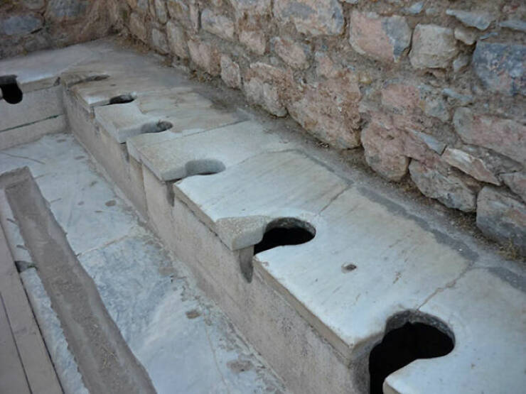 Oldest “Flush” Toilets (2,000 Years Old)

Ephesus, an ancient city in Turkey, had “flushing” toilets. Running water below the seats carried waste away into a nearby river.