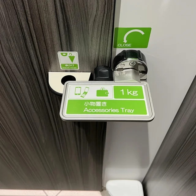 Door latch that doubles as an accessories holder at a public restroom in Japan. Simple concept, straightforward design, elegant execution.